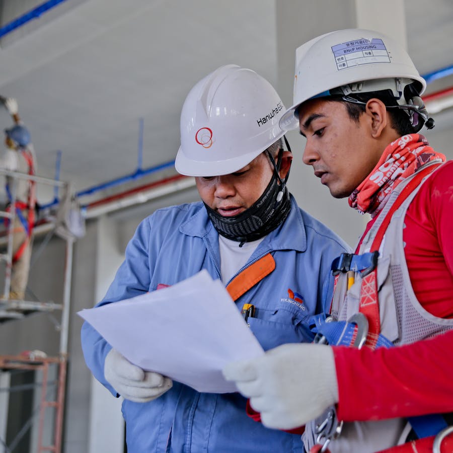 Tradies reviewing plans on site